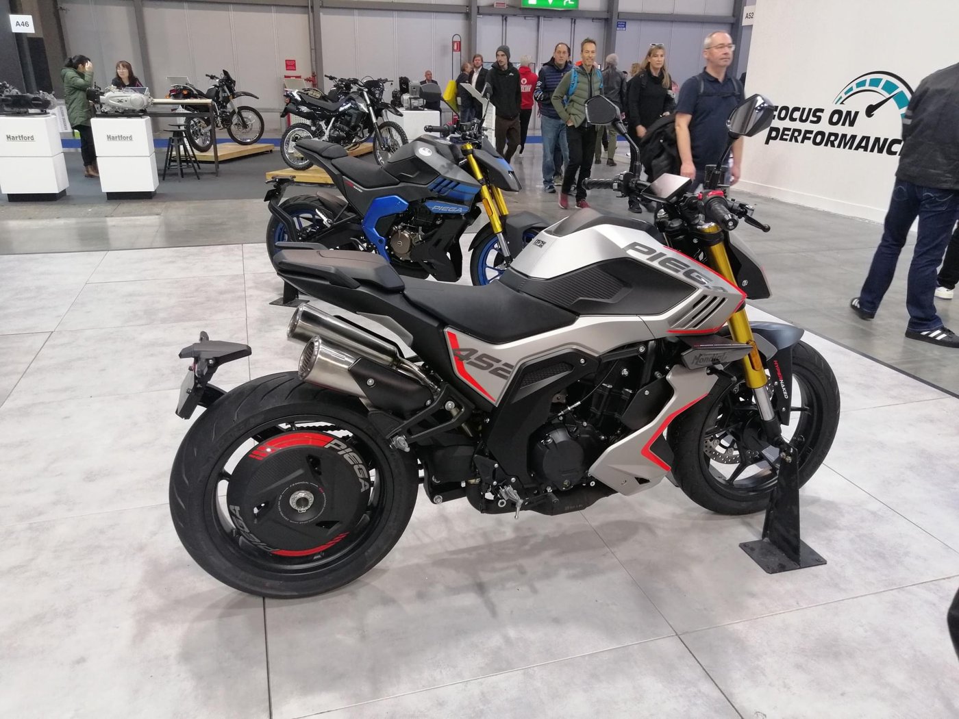 FB Mondial Piega 452 naked motorcycle in silver, black and red on a show stand