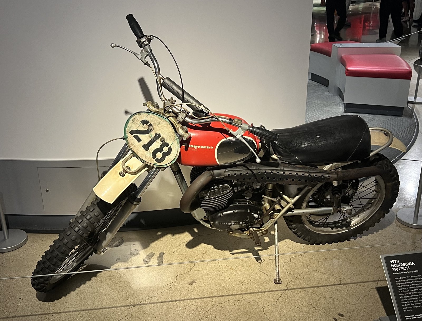 1970 Husqvarna 250 Cross with number plate 218, red tank and small Husqvarna script, on display at the Petersen Automotive Museum