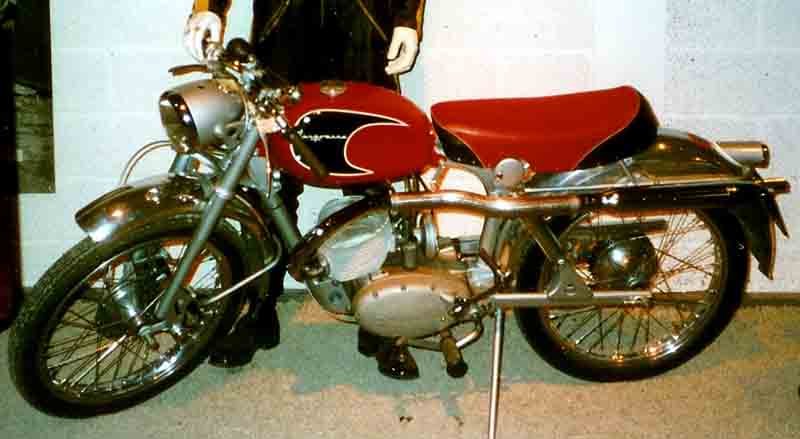 Husqvarna Silverpilen with a red tank carrying a black arrow-shaped flash with the Husqvarna script