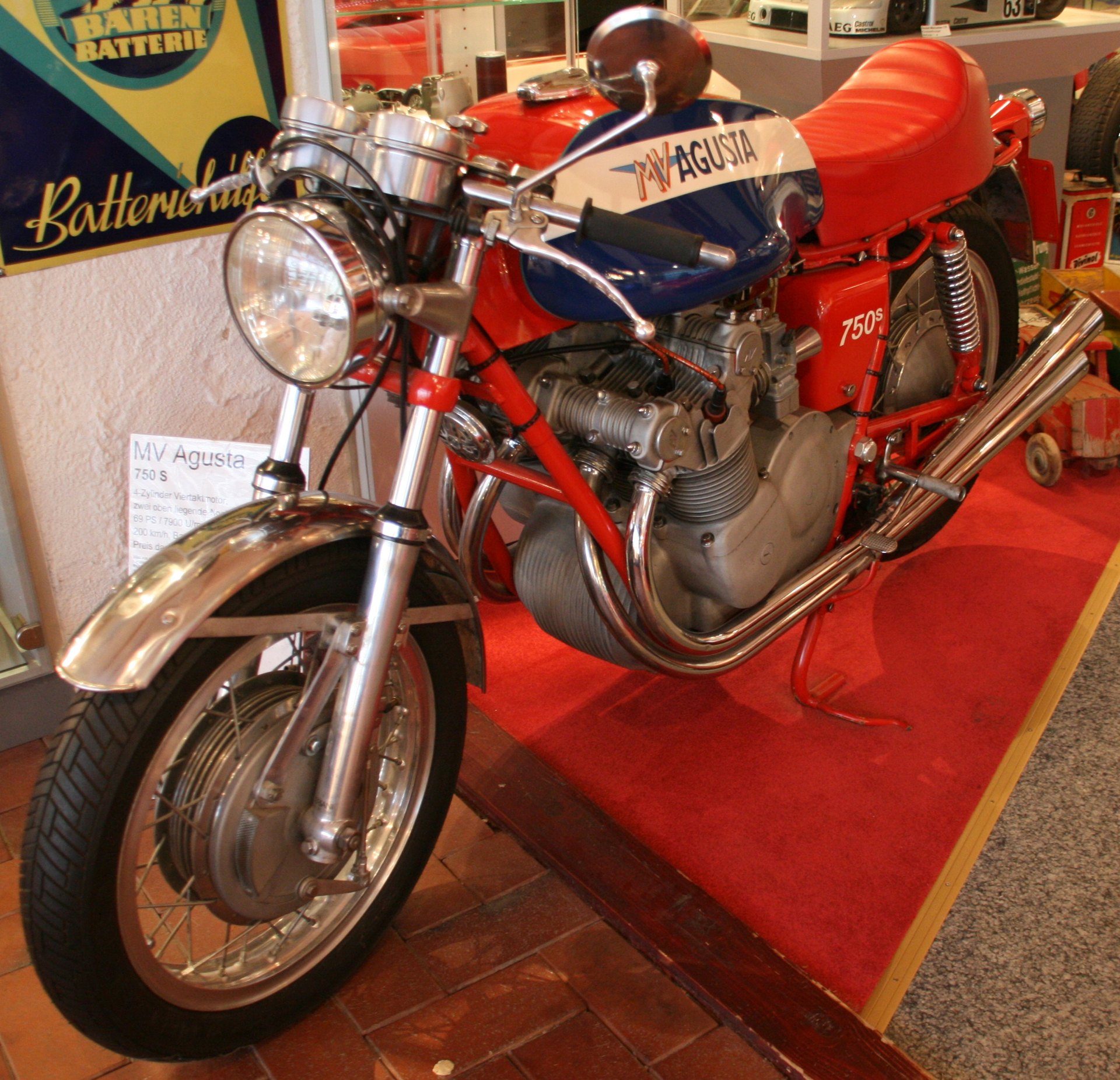 An MV Agusta 750 S on display with a red, white and blue tank carrying the MV AGUSTA wordmark in the white band
