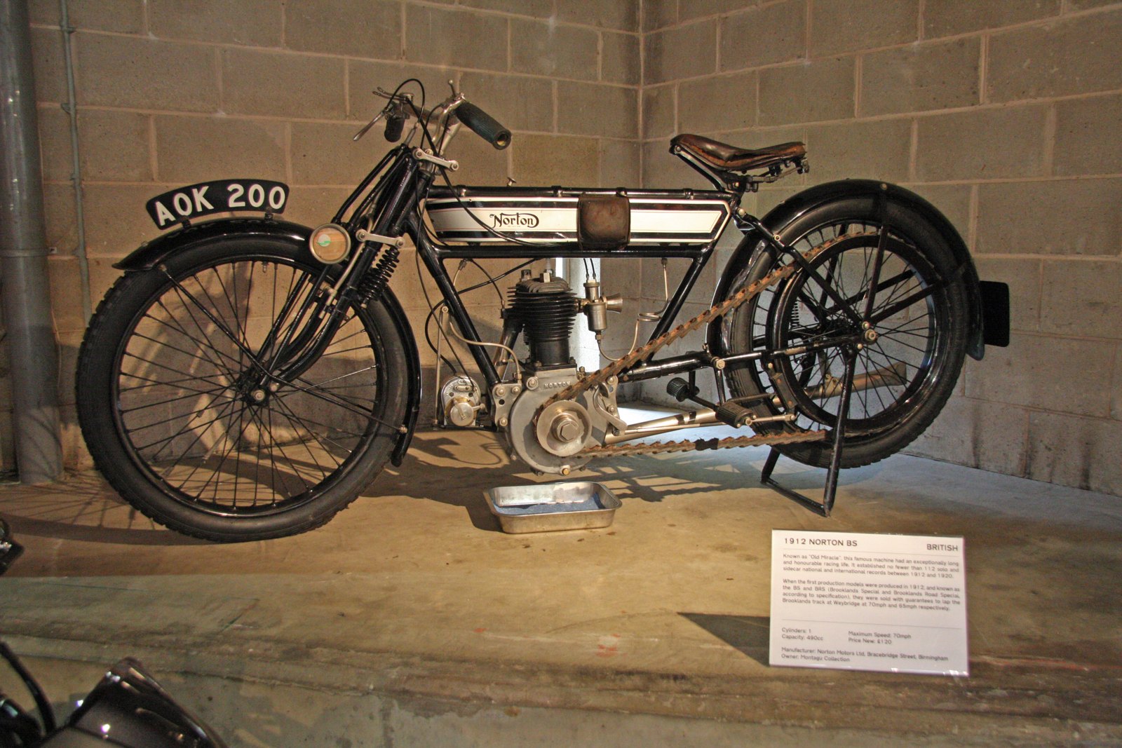 The 1912 Norton BS known as Old Miracle, registration AOK 200, with a curly N Norton transfer on a white band across its tank, on display at Beaulieu