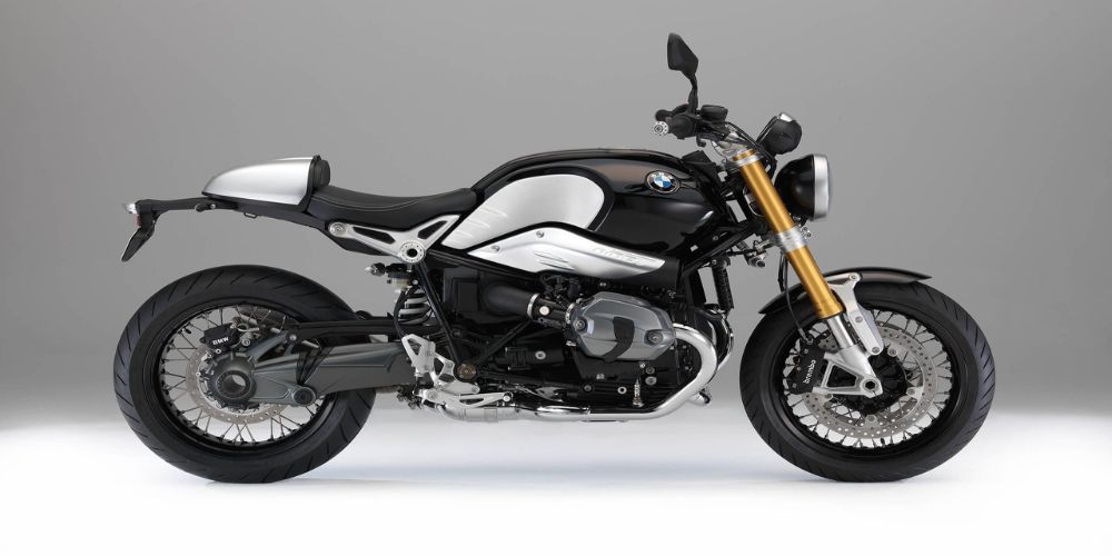 A 2015 BMW R Nine T black and white motorcycle is sitting on a white surface.