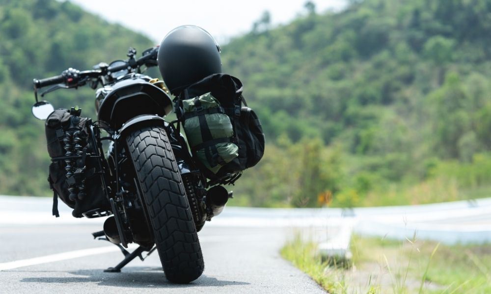 A motorcycle is parked on the side of a road.